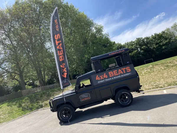 DJ truck at a school event with flags