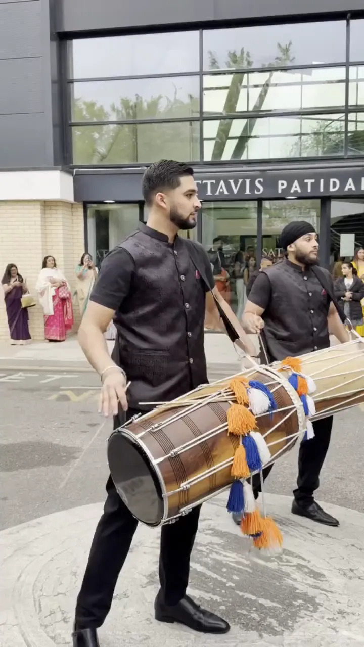 Dhol players and guests at a DJ truck baraat