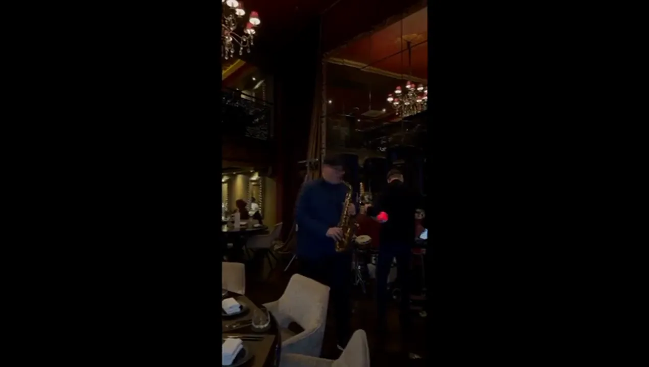 Saxophonist playing a set at an evening party