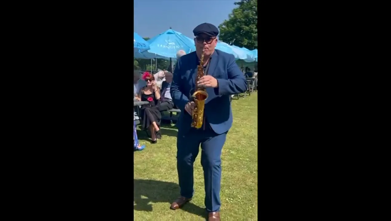 Saxophonist playing at an outdoor garden party