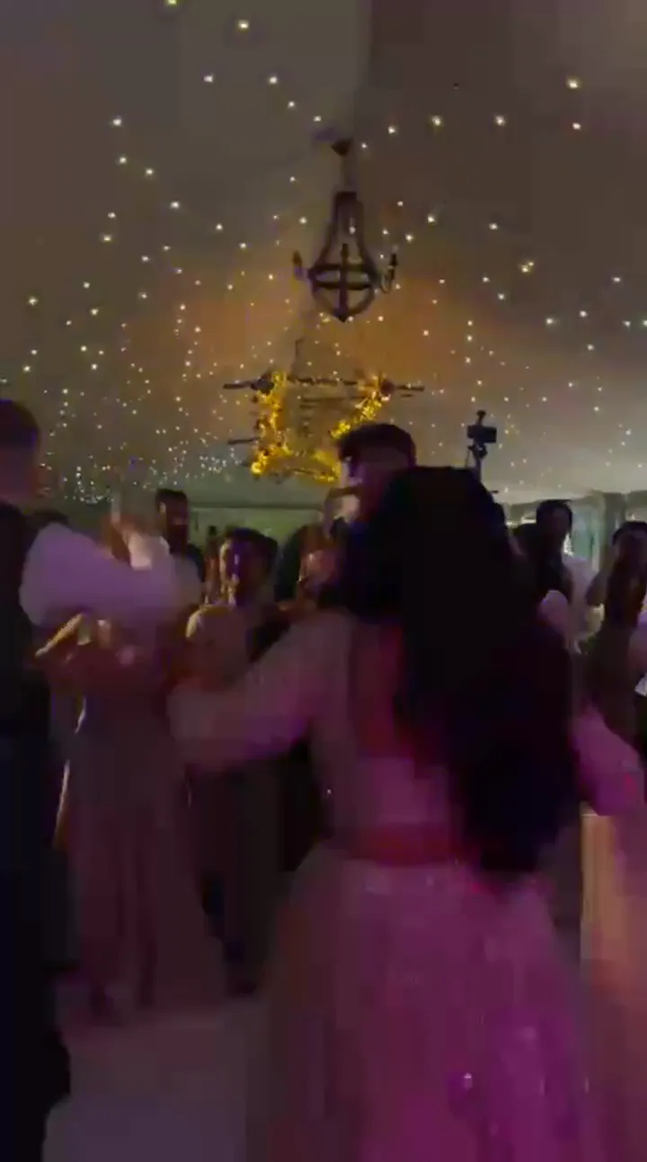 Bride dancing on the dancefloor while the saxophonist plays