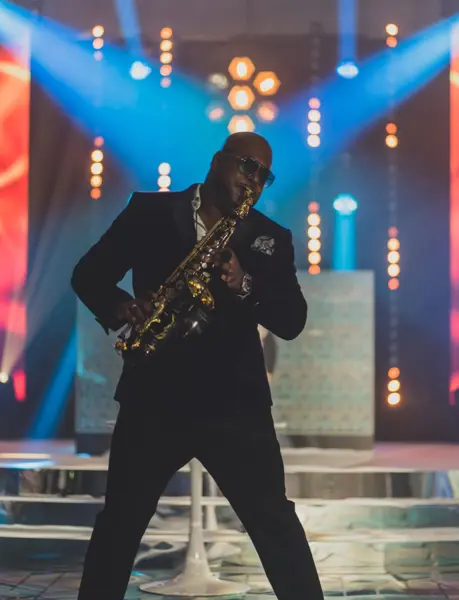 Saxophonist performing under blue and orange stage lights