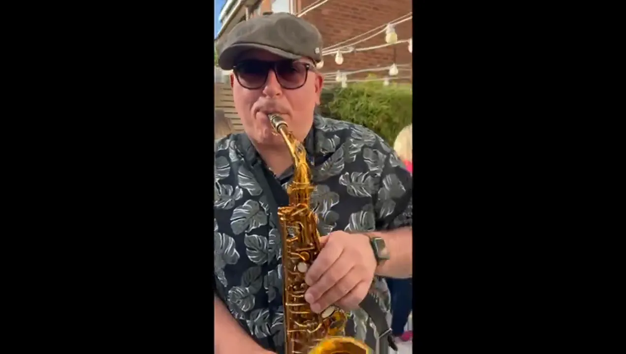 Guests enjoying live sax at a family celebration