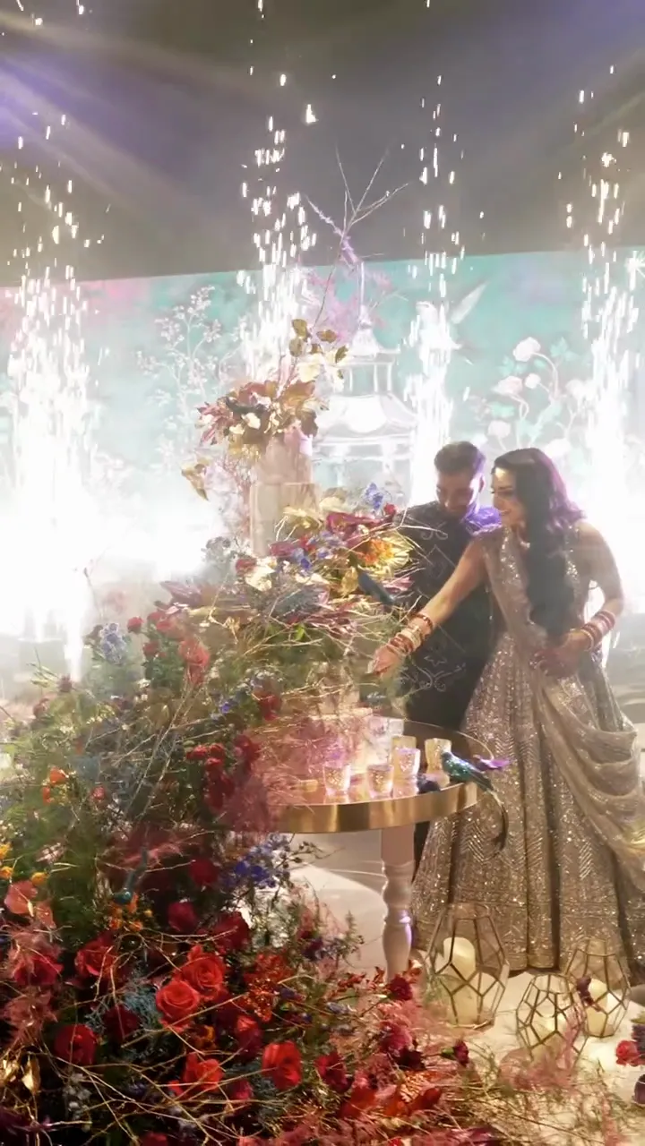 Saxophonist in sunglasses playing as the bride and groom walk in under sparklers