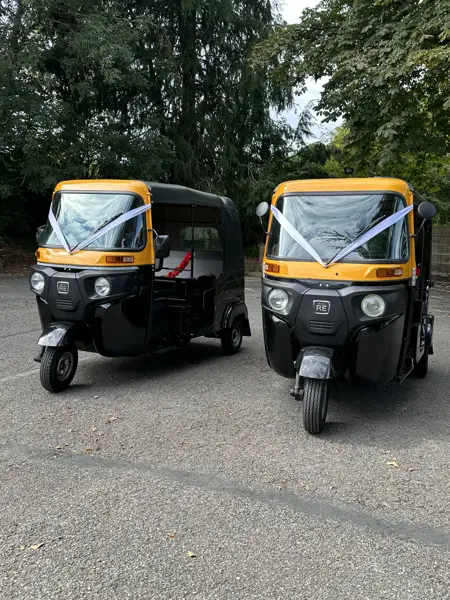 Two tuk tuks with ribbons ready for a wedding