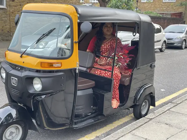 Bride in red sitting inside a tuk tuk