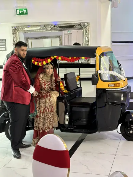 Couple in a tuk tuk inside a reception venue
