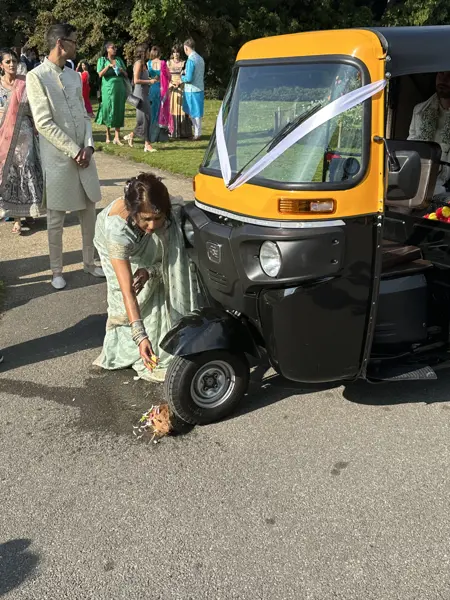 Wedding guests dancing beside a tuk tuk