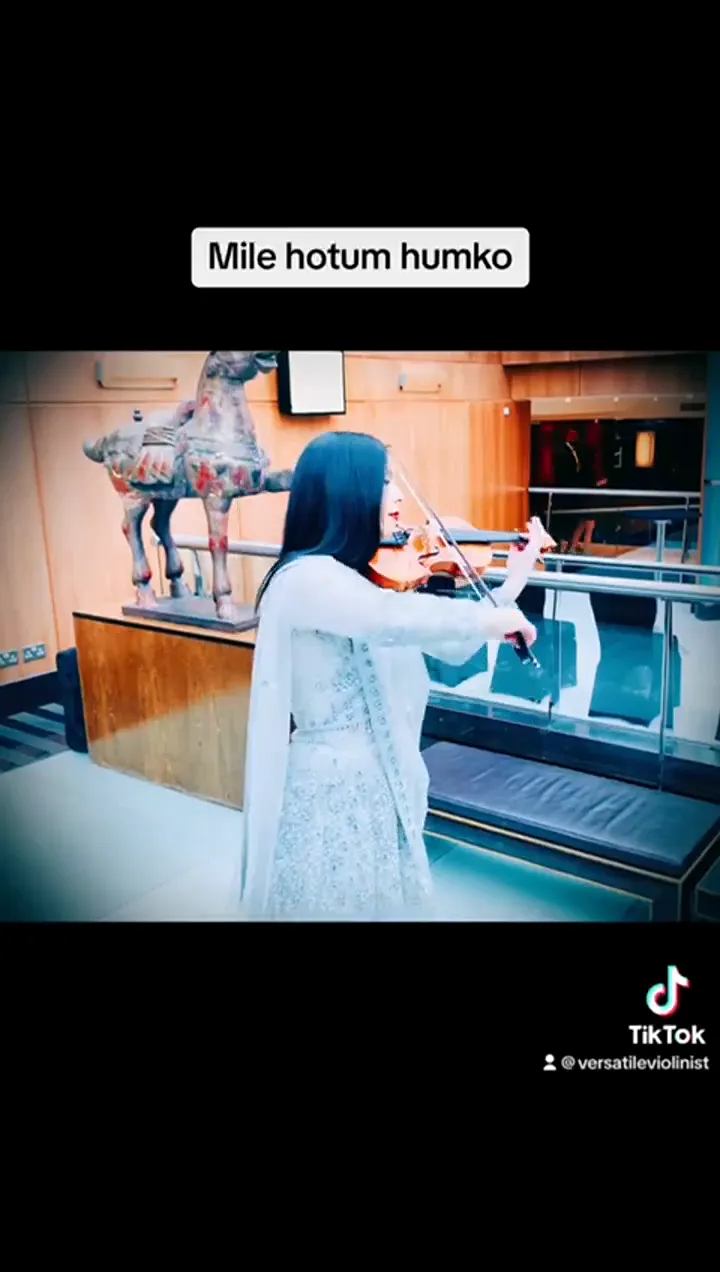 Violinist in white playing at a museum event venue