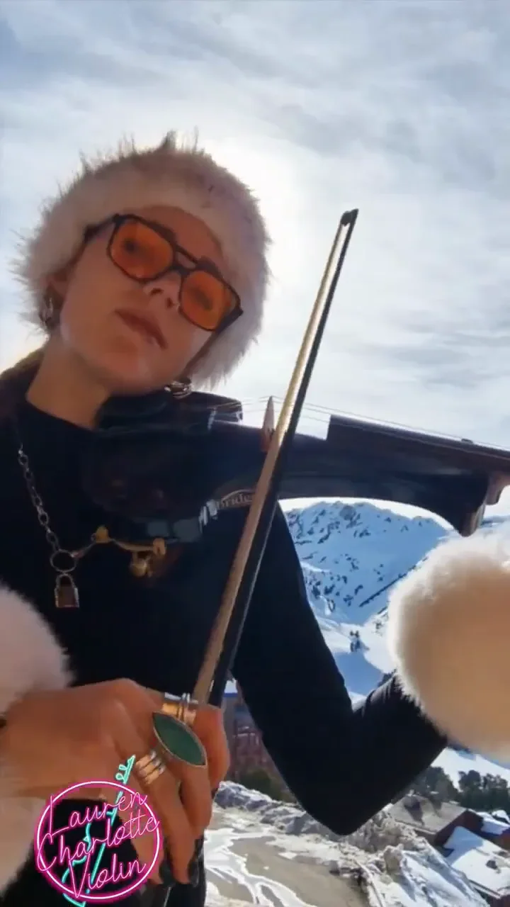 Violinist playing a Bollywood song outdoors in the snow