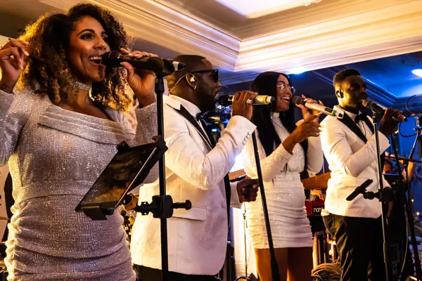 Live band performing as guests dance at an Asian wedding reception