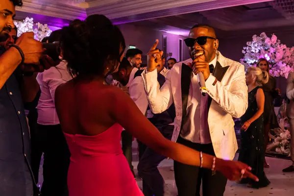 Live band performing as guests dance at an Asian wedding reception