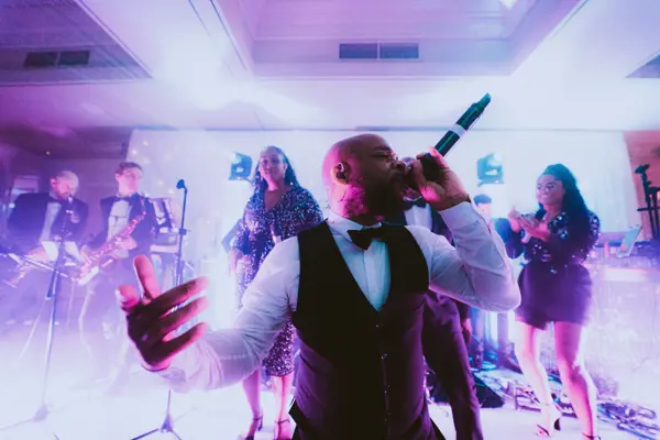 Singer performing to guests with the band behind