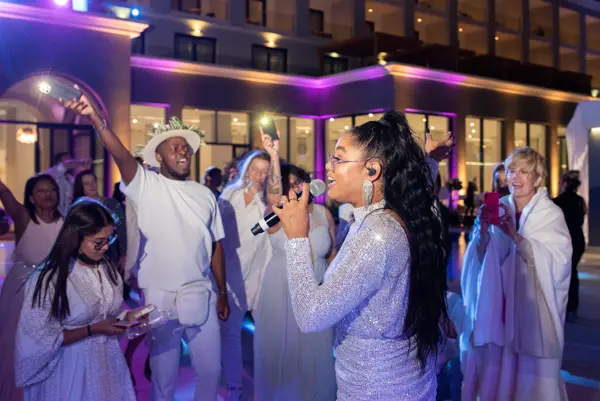 Band singers performing among dancing guests
