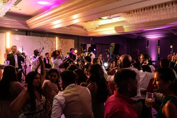 Live band performing as guests dance at an Asian wedding reception