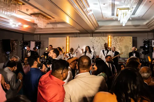 Live band performing as guests dance at an Asian wedding reception