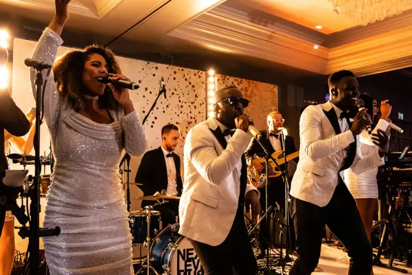 Live band performing as guests dance at an Asian wedding reception