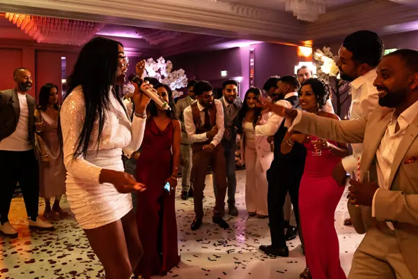 Live band performing as guests dance at an Asian wedding reception