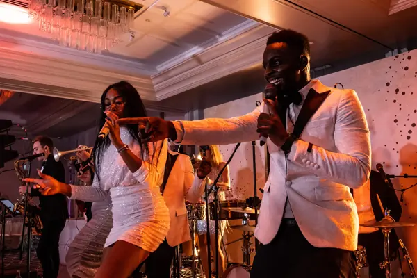 Live band performing as guests dance at an Asian wedding reception