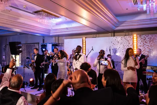 Live band performing as guests dance at an Asian wedding reception