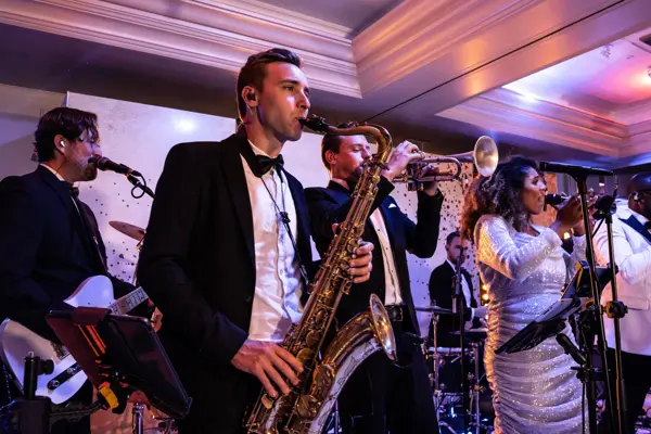 Live band performing as guests dance at an Asian wedding reception