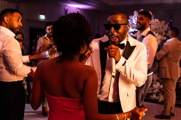 Live band performing as guests dance at an Asian wedding reception