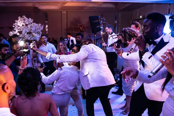Live band performing as guests dance at an Asian wedding reception