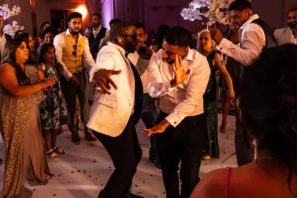 Live band performing as guests dance at an Asian wedding reception