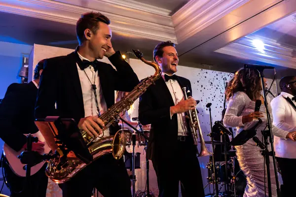 Live band performing as guests dance at an Asian wedding reception