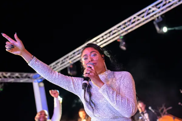 Singer performing to the crowd from an outdoor stage