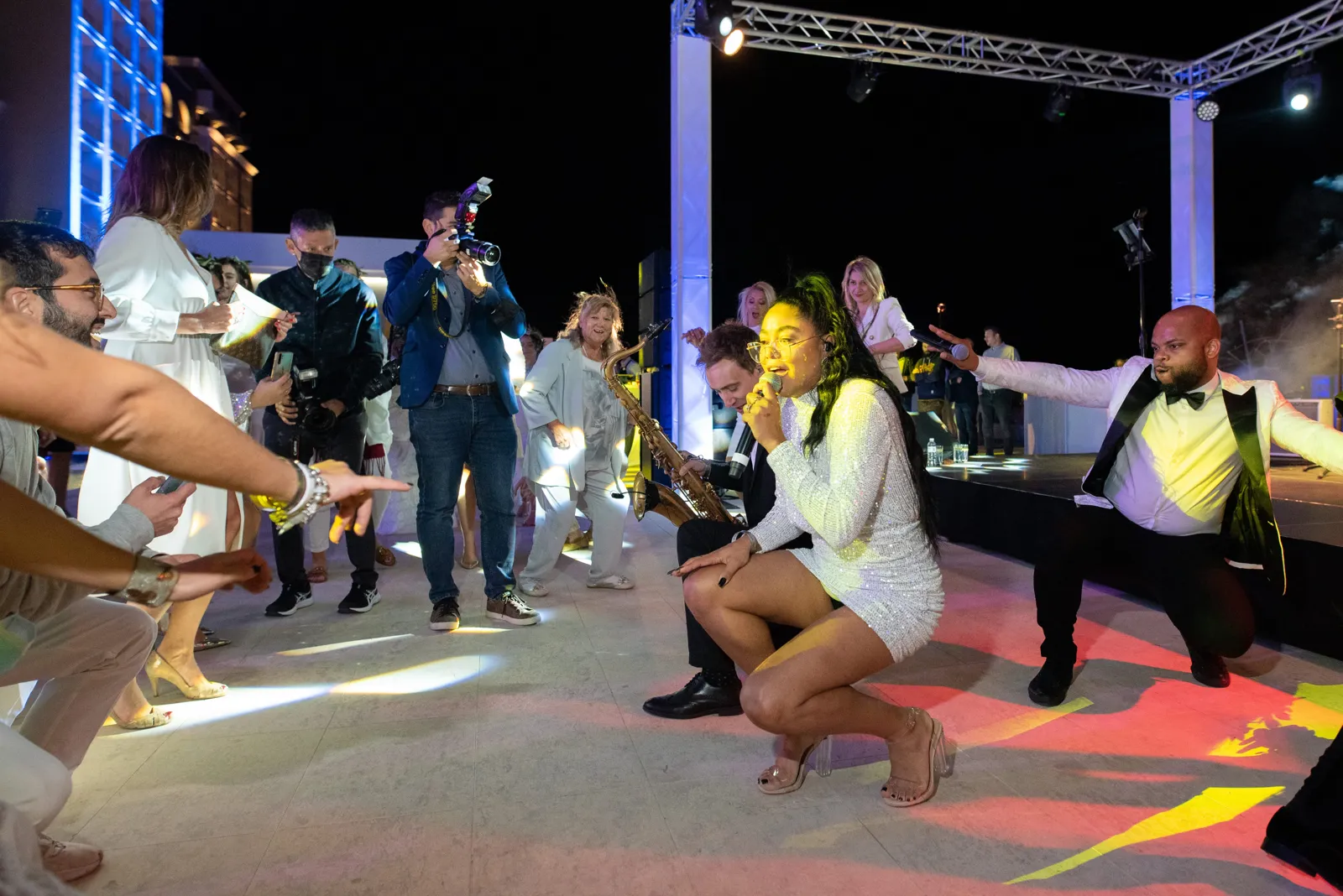 Band members playing on a packed dancefloor