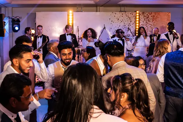 Live band performing as guests dance at an Asian wedding reception