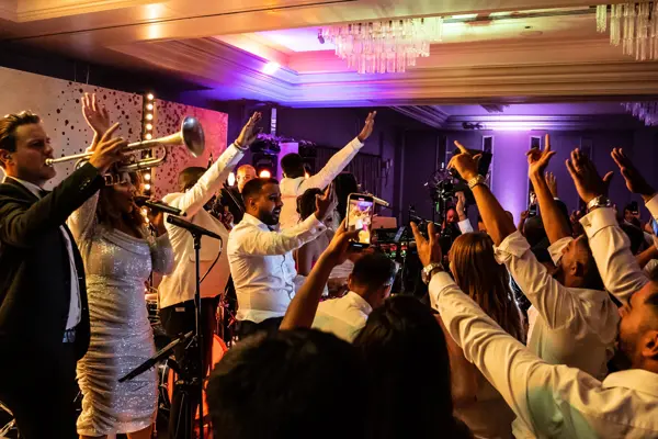 Live band performing as guests dance at an Asian wedding reception