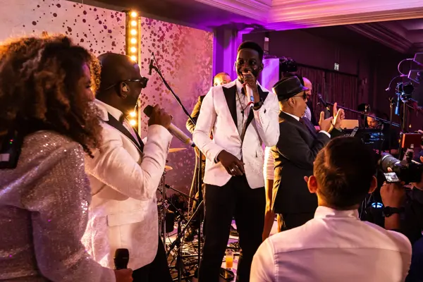 Live band performing as guests dance at an Asian wedding reception