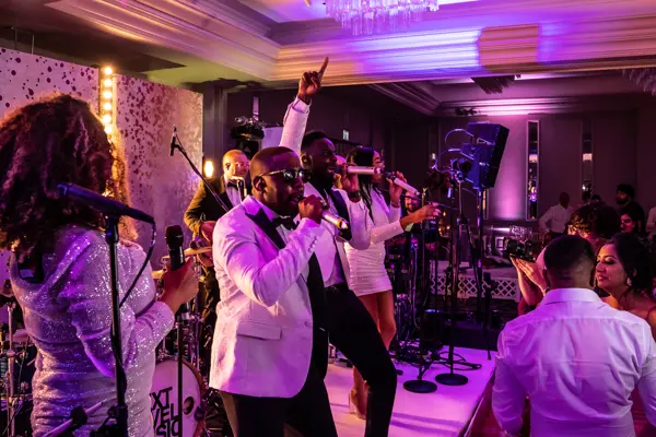 Live band performing as guests dance at an Asian wedding reception