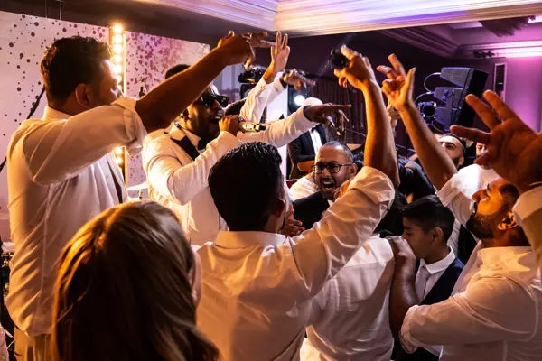 Live band performing as guests dance at an Asian wedding reception