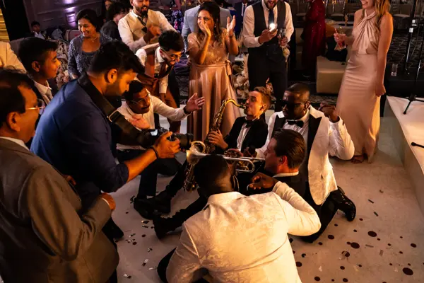 Live band performing as guests dance at an Asian wedding reception
